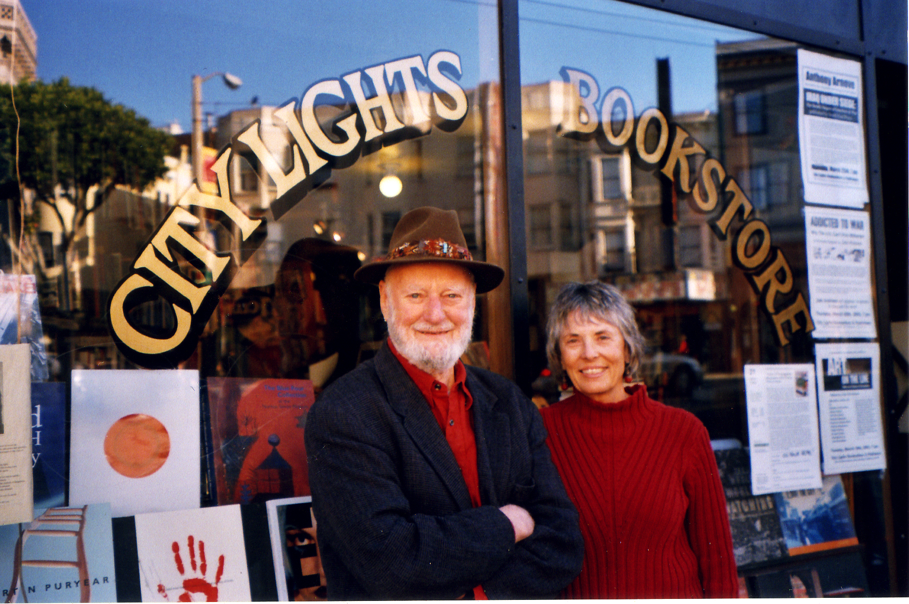 Lawrence Ferlinghetti and Nancy Peters posing together outside the store in 2001