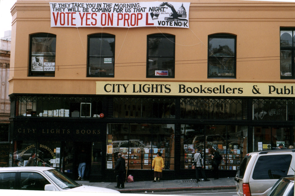 City Lights storefront with a large banner that reads VOTE YES ON PROP L 